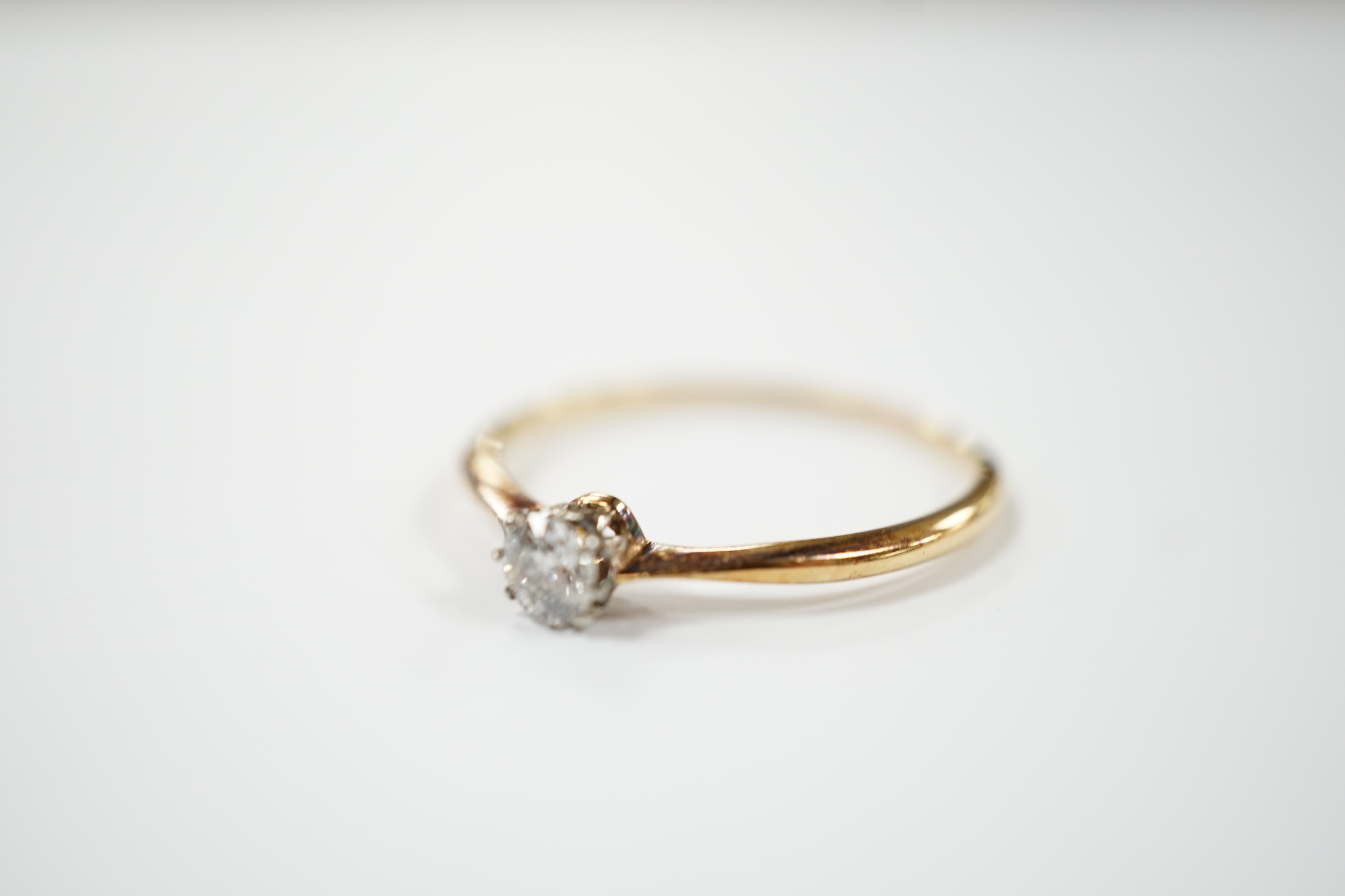 A yellow metal and solitaire diamond set ring, size V, gross weight 2 grams.